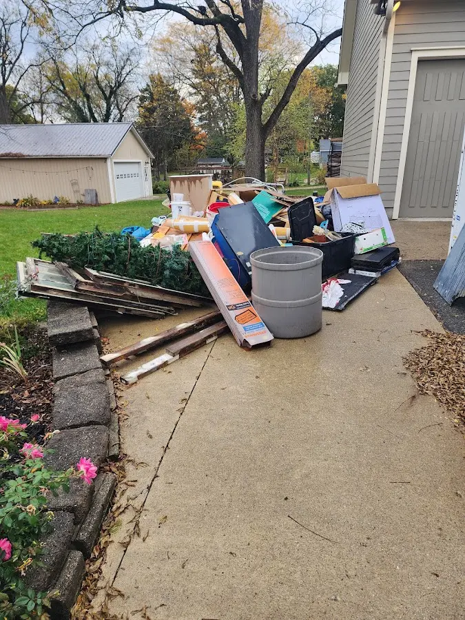 Dumpster being loaded with debris for Demolition Dumpster Rental in Greenville
